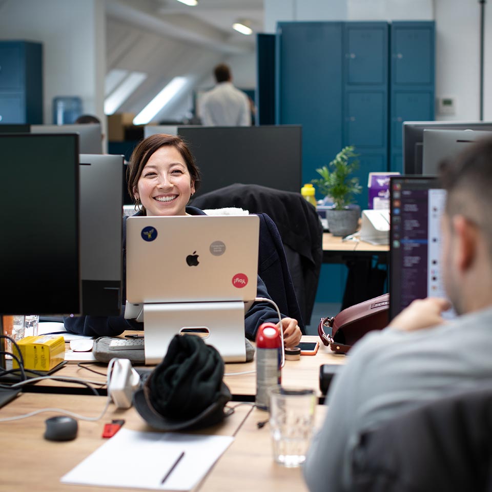 Smiling lady in the habito office, working, having a good time.